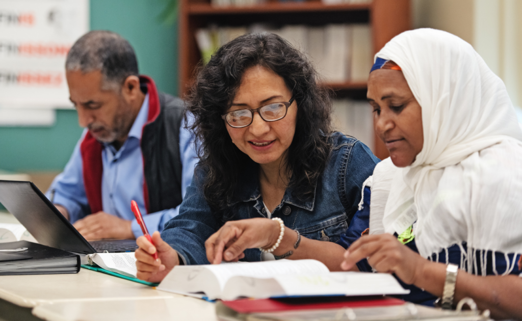 esl instructor works one on one with adult student