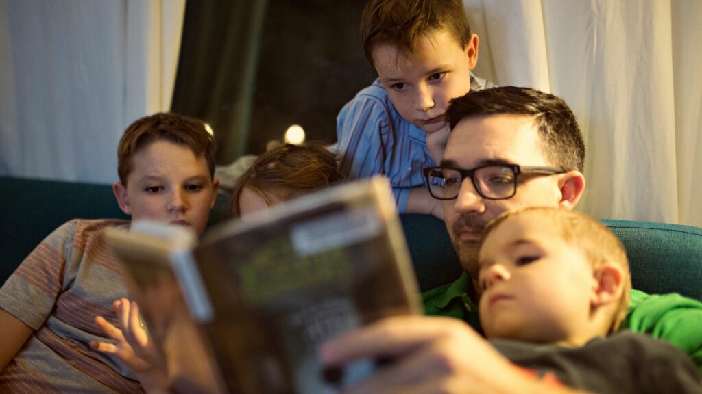 man reading to kids